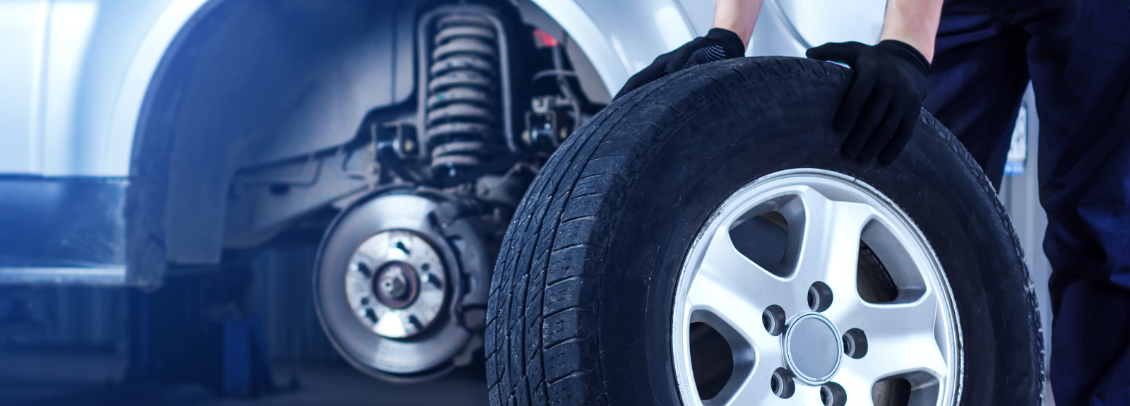Image of a mechanic holding a tyre - Order Car Tyres Online Kings Langley