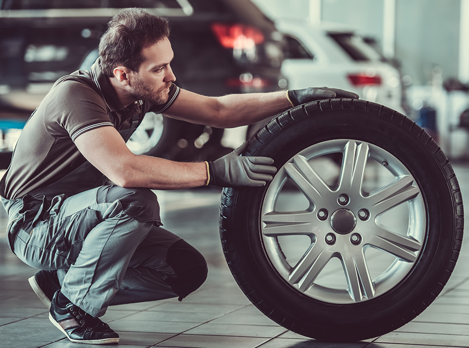 Mechanic checking over a tyre - Tyres Kings Langley